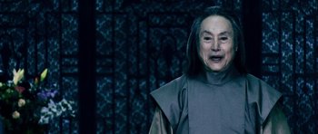 Movie still from “Goemon” (2009), directed by Kazuaki Kiriya – An older woman with long black hair wearing a gray robe; Close Up shot, Low angle