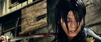 Movie still from “Goemon” (2009), directed by Kazuaki Kiriya – A person with a knife in their hand; Close Up shot, Low angle