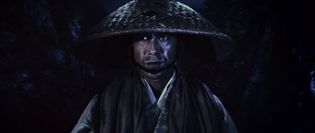 Movie still from “Goemon” (2009), directed by Kazuaki Kiriya – A man wearing a hat and a robe; Close Up shot, Low angle