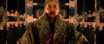 Movie still from “Goemon” (2009), directed by Kazuaki Kiriya – A man in a camouflage jacket and a scarf; Medium shot, Low angle