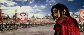 Movie still from “Goemon” (2009), directed by Kazuaki Kiriya – A man in a red jacket standing in front of a group of people; Close Up shot, Low angle