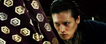Movie still from “Goemon” (2009), directed by Kazuaki Kiriya – A person wearing a costume; Close Up shot, Low angle