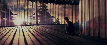 Movie still from “Goemon” (2009), directed by Kazuaki Kiriya – A person kneeling on the ground in front of a building; Extreme Wide shot, Low angle