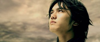 Movie still from “Goemon” (2009), directed by Kazuaki Kiriya – A young man looking up into the sky; Close Up shot, Low angle
