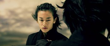 Movie still from “Goemon” (2009), directed by Kazuaki Kiriya – A man with long black hair looking into a mirror; Close Up shot, Over the shoulder angle