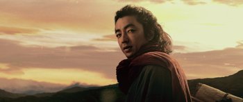 Movie still from “Goemon” (2009), directed by Kazuaki Kiriya – A man with long black hair wearing a red scarf; Close Up shot, Low angle