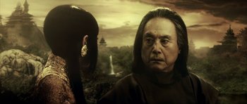 Movie still from “Goemon” (2009), directed by Kazuaki Kiriya – An older man and a younger woman in front of a waterfall; Close Up shot, Over the shoulder angle