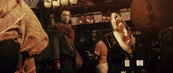 Movie still from “Goemon” (2009), directed by Kazuaki Kiriya – A man and a woman standing in front of a building; Medium shot, Low angle