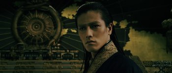 Movie still from “Goemon” (2009), directed by Kazuaki Kiriya – A man with long black hair wearing a black and gold outfit; Close Up shot, Low angle