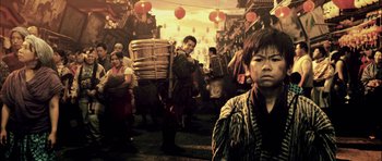 Movie still from “Goemon” (2009), directed by Kazuaki Kiriya – A group of people walking down a street; Medium shot, Over the shoulder angle