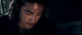 Movie still from “Goemon” (2009), directed by Kazuaki Kiriya – A man's face in the dark; Close Up shot, Low angle