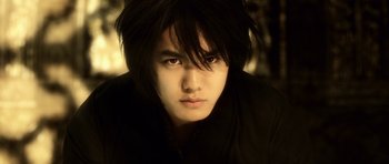 Movie still from “Goemon” (2009), directed by Kazuaki Kiriya – A man with long black hair is staring straight ahead; Close Up shot, Low angle