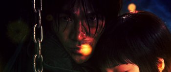 Movie still from “Goemon” (2009), directed by Kazuaki Kiriya – A man's face in the dark; Extreme Close Up shot, Overhead angle