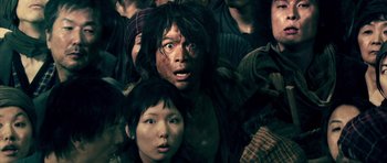 Movie still from “Goemon” (2009), directed by Kazuaki Kiriya – A man and a woman are standing in a crowd; Close Up shot, High angle