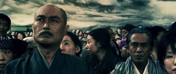 Movie still from “Goemon” (2009), directed by Kazuaki Kiriya – A group of people standing in a large crowd; Close Up shot, Low angle