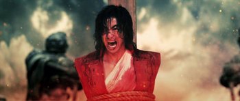 Movie still from “Goemon” (2009), directed by Kazuaki Kiriya – A painting of michael jackson hanging from a wooden pole; Medium shot, Low angle