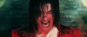 Movie still from “Goemon” (2009), directed by Kazuaki Kiriya – A person wearing a red shirt; Close Up shot, Low angle