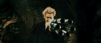 Movie still from “Goemon” (2009), directed by Kazuaki Kiriya – A man in a black robe is holding a gun; Medium shot, Low angle