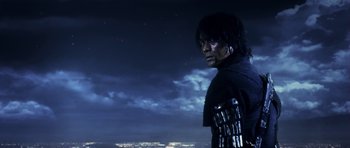 Movie still from “Goemon” (2009), directed by Kazuaki Kiriya – A man in a black jacket standing in front of a night sky; Medium shot, Low angle