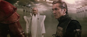 Movie still from “Goemon” (2009), directed by Kazuaki Kiriya – Two men standing next to each other in front of a painting; Medium shot, Low angle