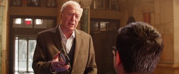 Movie still from “Going in Style” (2017), directed by Zach Braff – An older man in a brown suit talking to a young man; Medium shot, Over the shoulder angle