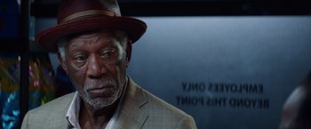 Movie still from “Going in Style” (2017), directed by Zach Braff – An older man wearing a suit and a hat; Close Up shot, Over the shoulder angle