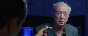 Movie still from “Going in Style” (2017), directed by Zach Braff – An older man smoking a cigarette in front of a mirror; Close Up shot, Over the shoulder angle