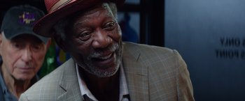 Movie still from “Going in Style” (2017), directed by Zach Braff – An older man wearing a suit and a red hat; Close Up shot, Low angle