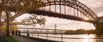 Movie still from “Going in Style” (2017), directed by Zach Braff – A view of a bridge from across the river; Extreme Wide shot, Low angle