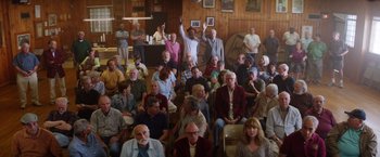 Movie still from “Going in Style” (2017), directed by Zach Braff – A large group of people sitting in a room; Wide shot, High angle