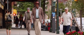Movie still from “Going in Style” (2017), directed by Zach Braff – Two men walking down the sidewalk in a city; Wide shot, Low angle