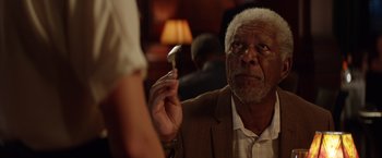 Movie still from “Going in Style” (2017), directed by Zach Braff – An older man holding a spoon in his right hand; Close Up shot, Over the shoulder angle