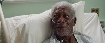 Movie still from “Going in Style” (2017), directed by Zach Braff – An older man laying in a hospital bed with an oxygen mask on; Close Up shot, Overhead angle