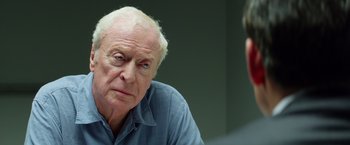Movie still from “Going in Style” (2017), directed by Zach Braff – An older man sitting in front of a younger man; Close Up shot, Over the shoulder angle