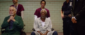 Movie still from “Going in Style” (2017), directed by Zach Braff – An older man sitting in front of a young man; Medium shot, High angle