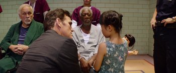Movie still from “Going in Style” (2017), directed by Zach Braff – An older man sitting in front of two young girls; Medium shot, Over the shoulder angle