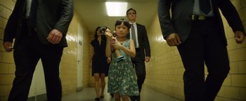 Movie still from “Going in Style” (2017), directed by Zach Braff – A little girl holding an ice cream cone in a hallway; Medium shot, Low angle