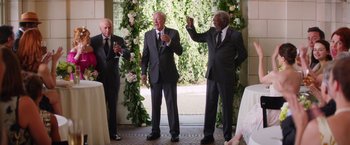 Movie still from “Going in Style” (2017), directed by Zach Braff – A group of men standing next to each other on a porch; Wide shot, Over the shoulder angle
