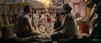 Movie still from “Goliyon Ki Raasleela Ram Leela” (2013), directed by Sanjay Leela Bhansali – A group of people walking down a street; Wide shot, Over the shoulder angle