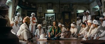 Movie still from “Goliyon Ki Raasleela Ram Leela” (2013), directed by Sanjay Leela Bhansali – A group of men sitting on the floor of a room; Wide shot, Low angle