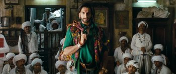 Movie still from “Goliyon Ki Raasleela Ram Leela” (2013), directed by Sanjay Leela Bhansali – A man in a green shirt and a bunch of other men; Medium shot, Low angle