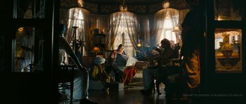 Movie still from “Goliyon Ki Raasleela Ram Leela” (2013), directed by Sanjay Leela Bhansali – A group of people sitting in a living room; Wide shot, Low angle