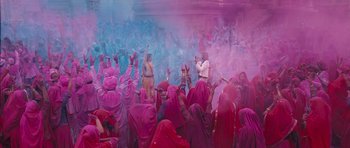 Movie still from “Goliyon Ki Raasleela Ram Leela” (2013), directed by Sanjay Leela Bhansali – A group of people are covered in colored powder; Wide shot, Overhead angle