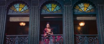 Movie still from “Goliyon Ki Raasleela Ram Leela” (2013), directed by Sanjay Leela Bhansali – A woman standing on a balcony looking out a window; Wide shot, Low angle