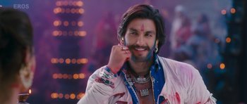Movie still from “Goliyon Ki Raasleela Ram Leela” (2013), directed by Sanjay Leela Bhansali – A man with long brown hair is smiling; Close Up shot, Low angle