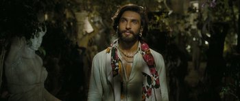 Movie still from “Goliyon Ki Raasleela Ram Leela” (2013), directed by Sanjay Leela Bhansali – A man with long hair wearing a white shirt and a floral scarf; Close Up shot, Over the shoulder angle