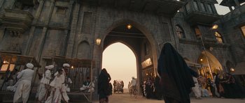 Movie still from “Goliyon Ki Raasleela Ram Leela” (2013), directed by Sanjay Leela Bhansali – A group of people standing under an archway on a street; Extreme Wide shot, Low angle