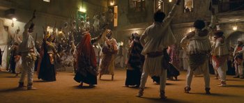 Movie still from “Goliyon Ki Raasleela Ram Leela” (2013), directed by Sanjay Leela Bhansali – A group of people dancing on a street at night; Wide shot, High angle