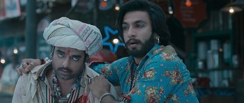 A man with long hair and a beard is wearing a turban