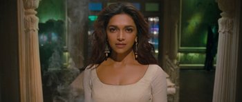 Movie still from “Goliyon Ki Raasleela Ram Leela” (2013), directed by Sanjay Leela Bhansali – Deepika padukon in a white dress with dangling earrings; Close Up shot, Over the shoulder angle